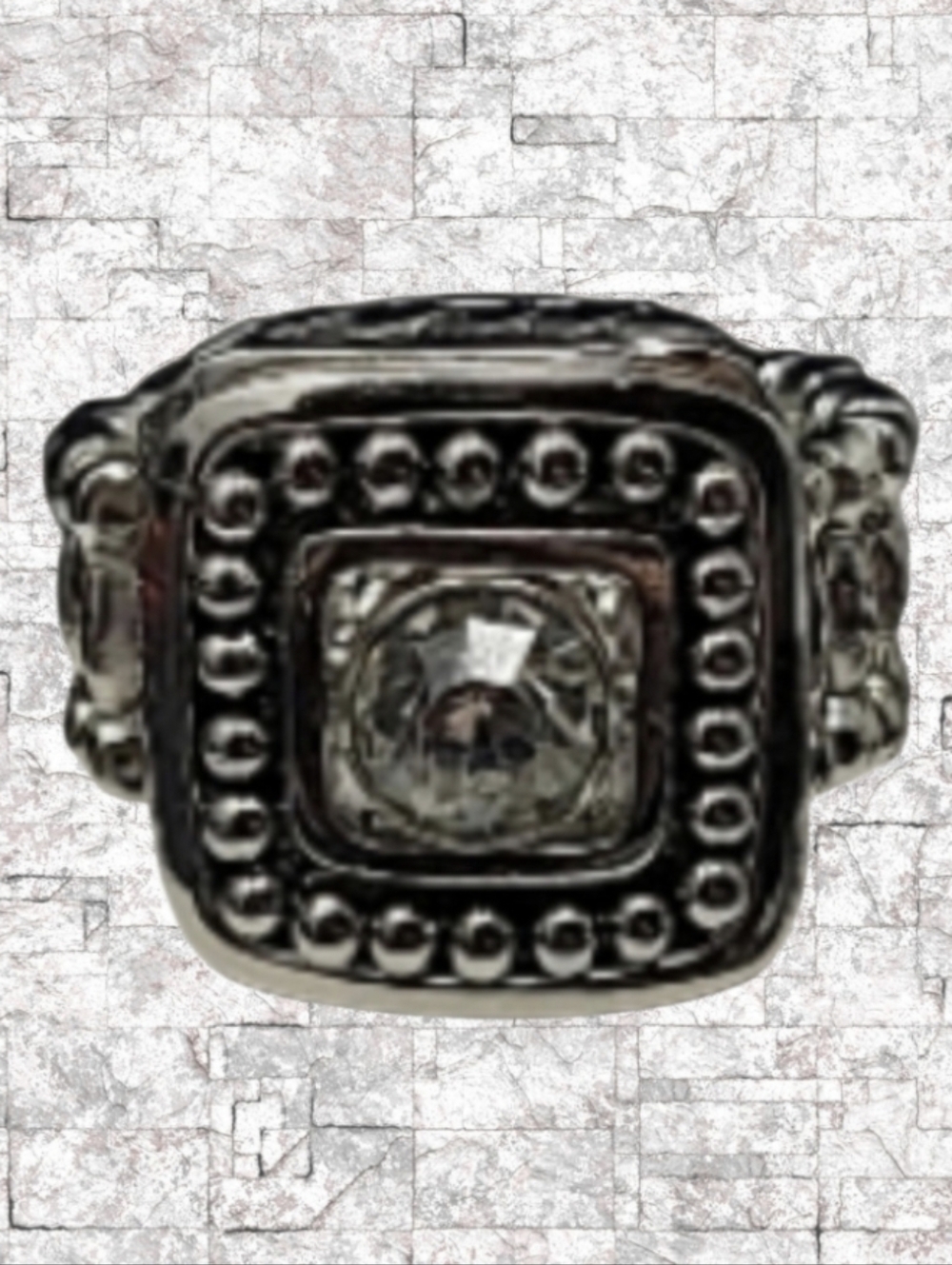 SILVER TONE METAL WITH A LARGE CLEAR RHINESTONE STRETCH RING (COSTUME JEWELRY)